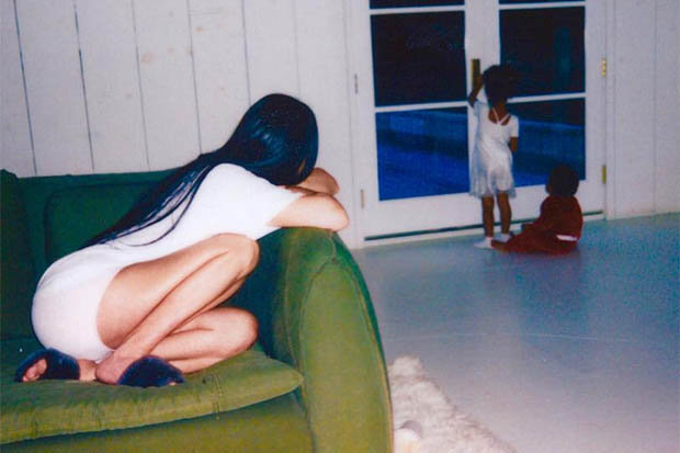 Kim Kardashian sitting on sofa
